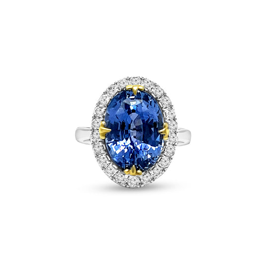 A, captivating, oval, sapphire, center, stone, surrounded, by, sparkling, diamonds, set, in, a, halo, design, atop, a, polished, band.