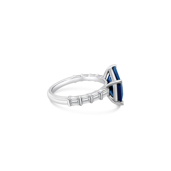"Radiant sapphire ring, blue gemstone jewelry, sparkling diamond accents, elegant gemstone ring, luxury jewelry, statement ring, fine jewelry piece, special occasion accessory."