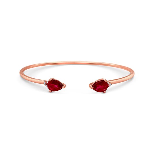 A pear-shaped ruby and diamond bracelet. Pear-shaped ruby, diamond-studded bracelet, elegant jewelry piece, luxurious accessory, gemstone-studded wristlet.A stunning pear-shaped ruby bracelet, featuring deep red gemstones, set in gleaming gold, perfect for adding a touch of elegance to any outfit, suitable for formal occasions or everyday wear, a timeless piece of jewelry that exudes sophistication and luxury.