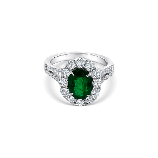 Oval emerald and diamond halo ring, showcasing a vibrant green emerald surrounded by sparkling diamonds, perfect for adding elegance and sophistication to any ensemble.