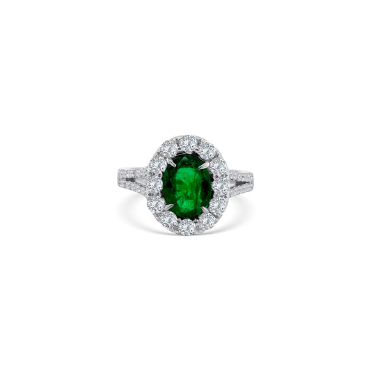 Oval emerald and diamond halo ring, showcasing a vibrant green emerald surrounded by sparkling diamonds, perfect for adding elegance and sophistication to any ensemble.