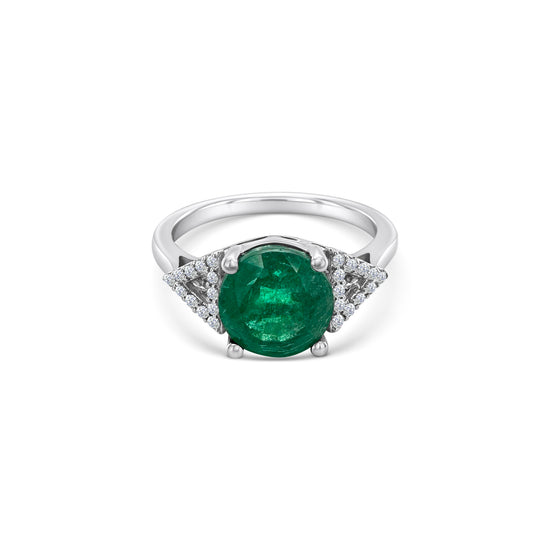 A round emerald & diamond halo ring, exquisite emerald and diamond ring, stunning emerald and diamond jewelry, elegant emerald and diamond engagement ring, beautiful emerald and diamond cocktail ring, luxurious emerald and diamond statement piece, captivating emerald and diamond accessory.