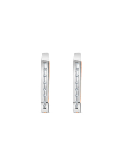 Elegant baguette cut diamond huggy earrings in white gold, Close-up of sparkling baguette cut diamond hoop earrings, Luxury diamond huggy earrings with baguette cut stones, Pair of baguette cut diamond huggies for women, Baguette diamond huggy earrings with secure clasp, Fine jewelry baguette diamond huggies in gold