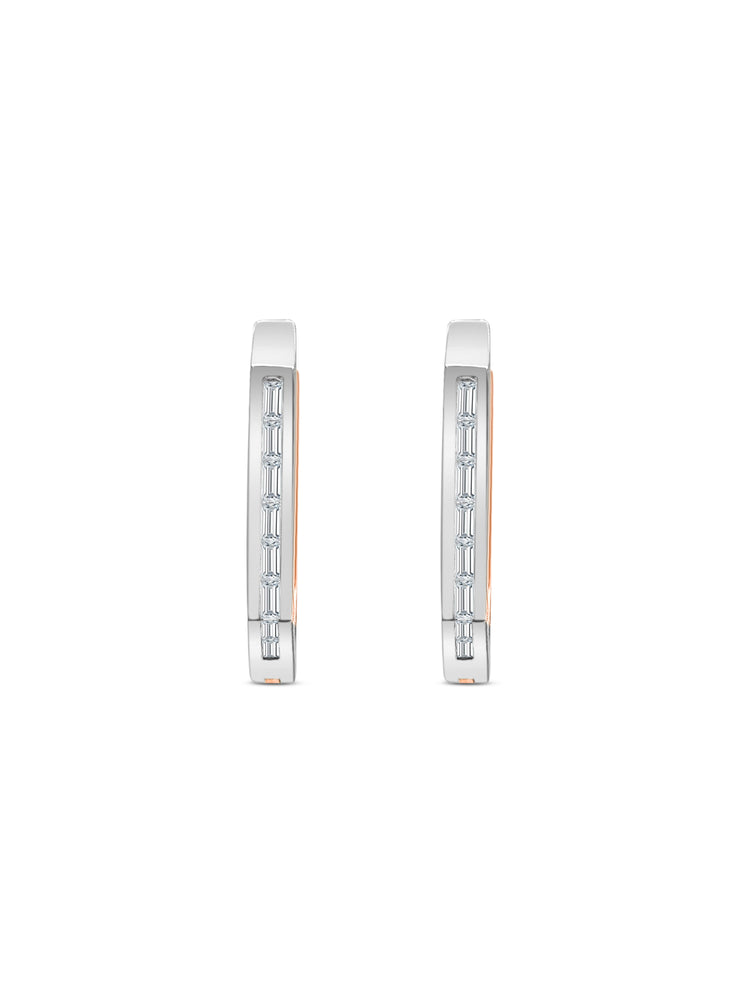 Elegant baguette cut diamond huggy earrings in white gold, Close-up of sparkling baguette cut diamond hoop earrings, Luxury diamond huggy earrings with baguette cut stones, Pair of baguette cut diamond huggies for women, Baguette diamond huggy earrings with secure clasp, Fine jewelry baguette diamond huggies in gold