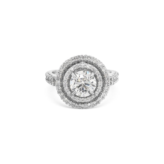 Round brilliant cut diamond ring with double halo setting, Elegant double halo ring featuring round brilliant diamond center, Luxury round diamond engagement ring with double halo design, White gold ring with round brilliant diamond and double halo, Sparkling round cut diamond ring with double halo of accent stones, Round brilliant engagement ring with intricate double halo, Classic round brilliant cut diamond ring in double halo setting