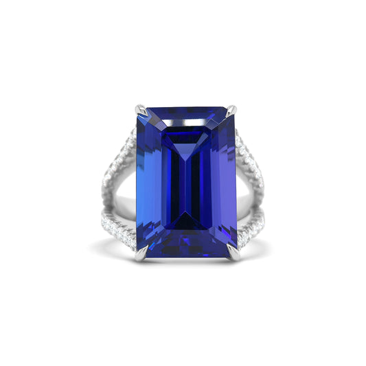 Emerald cut tanzanite ring with split shank diamond band, Elegant emerald cut tanzanite and diamond ring with split shank design, Split shank ring featuring vibrant emerald cut tanzanite center stone, White gold ring with emerald cut tanzanite and diamond accents, Luxurious emerald cut tanzanite ring framed by split shank diamonds, Statement ring with emerald cut tanzanite and diamond split shank, Modern split shank diamond ring with vivid emerald cut tanzanite