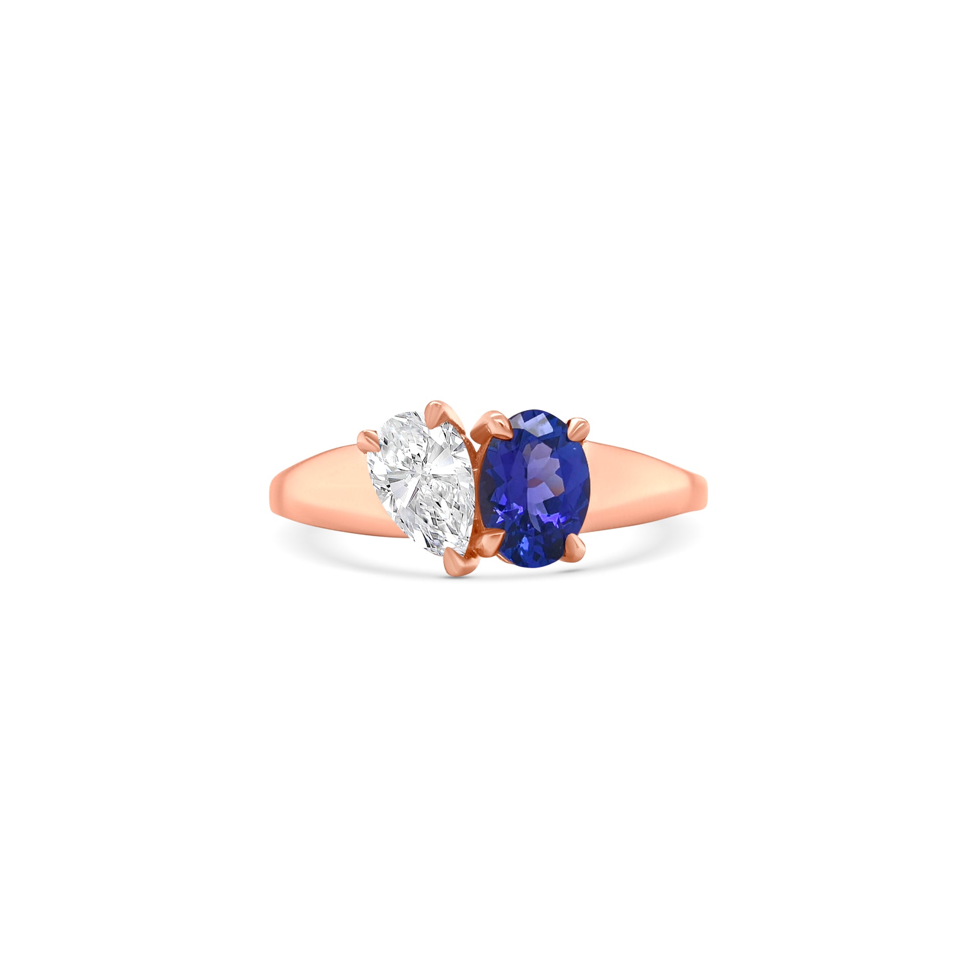 Elegant oval-cut tanzanite ring flanked by sparkling pear-shaped diamonds, set in a polished metal band.