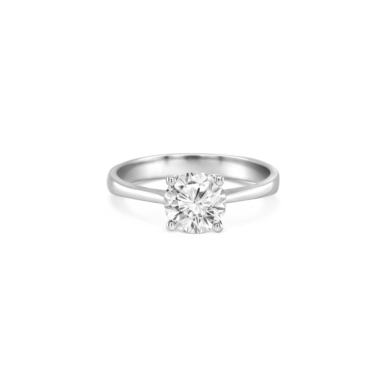 round brilliant solitaire diamond ring, solitaire engagement ring, classic diamond solitaire, round cut diamond ring, elegant diamond ring, timeless solitaire jewelry, women’s engagement ring, white gold solitaire ring, fine diamond jewelry, luxury solitaire diamond