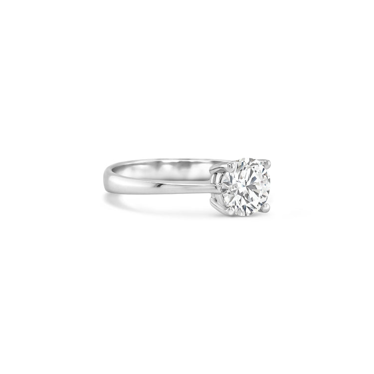 round brilliant solitaire diamond ring, solitaire engagement ring, classic diamond solitaire, round cut diamond ring, elegant diamond ring, timeless solitaire jewelry, women’s engagement ring, white gold solitaire ring, fine diamond jewelry, luxury solitaire diamond