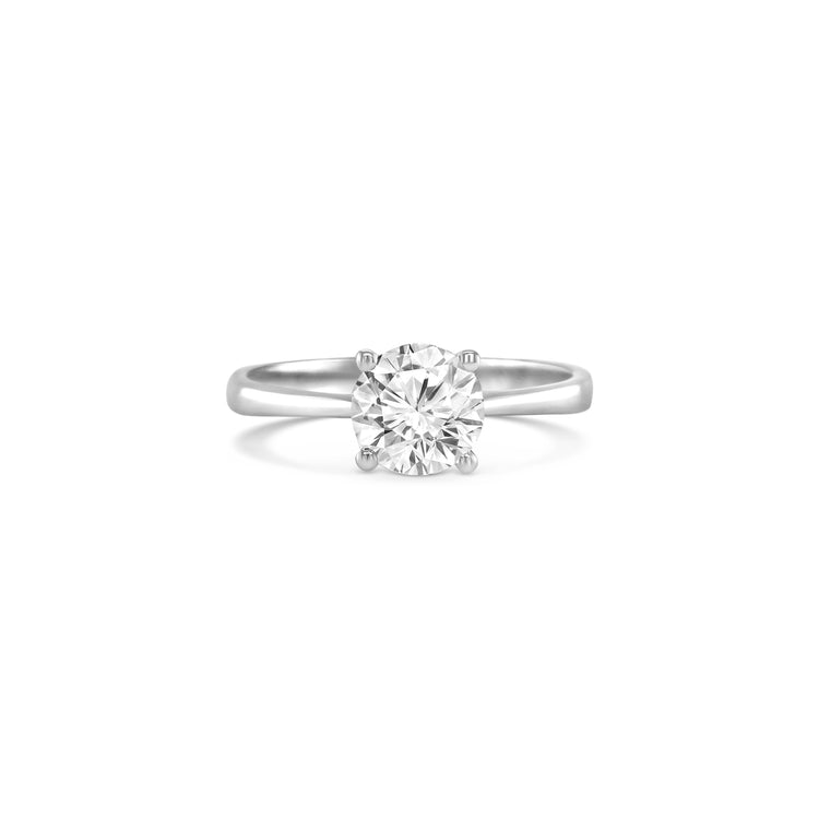 round brilliant solitaire diamond ring, solitaire engagement ring, classic diamond solitaire, round cut diamond ring, elegant diamond ring, timeless solitaire jewelry, women’s engagement ring, white gold solitaire ring, fine diamond jewelry, luxury solitaire diamond