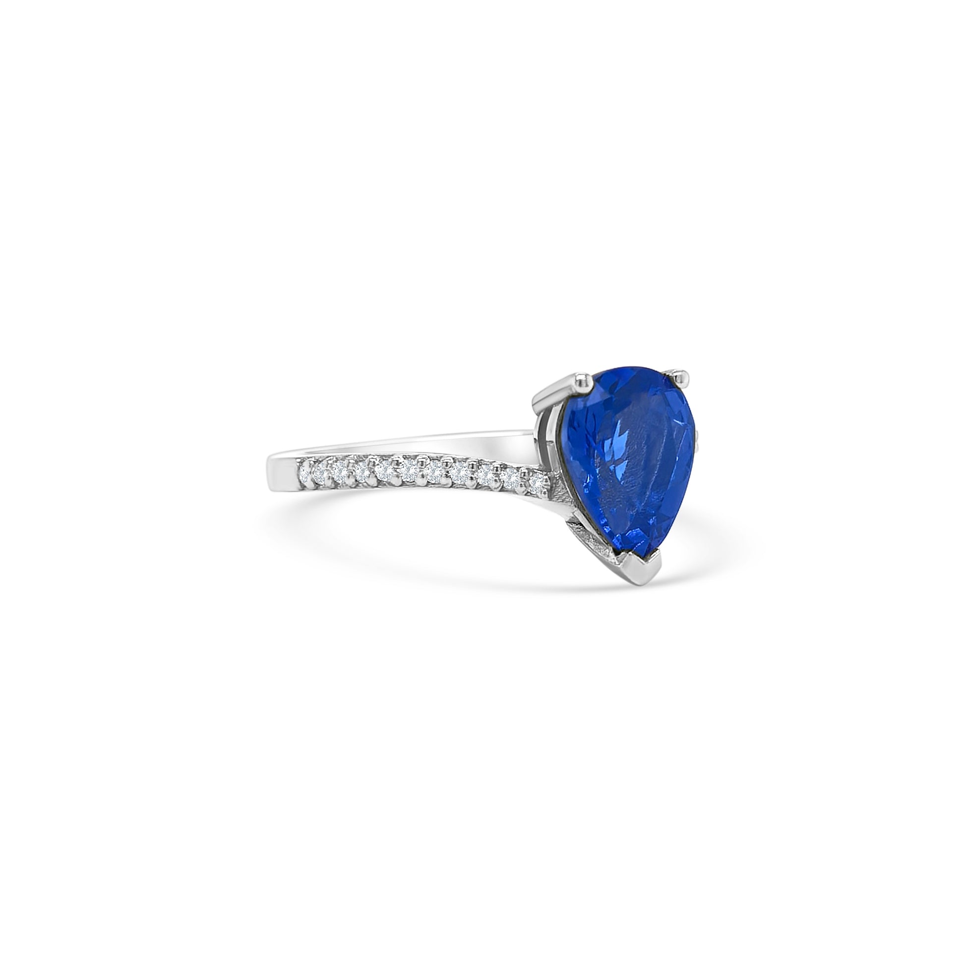 pear shape tanzanite ring, pear cut gemstone ring, tanzanite and diamond ring, elegant pear cut tanzanite jewelry, luxury gemstone ring, women’s tanzanite diamond ring, pear shaped engagement style ring, fine gemstone jewelry, white gold tanzanite and diamond ring, sparkling pear cut tanzanite ring