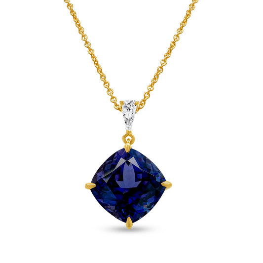 A cushion cut tanzanite pendant, sparkling with diamonds, radiant gemstone jewelry, luxurious tanzanite necklace, dazzling diamond and tanzanite pendant, elegant gemstone pendant, exquisite cushion cut tanzanite and diamond necklace.