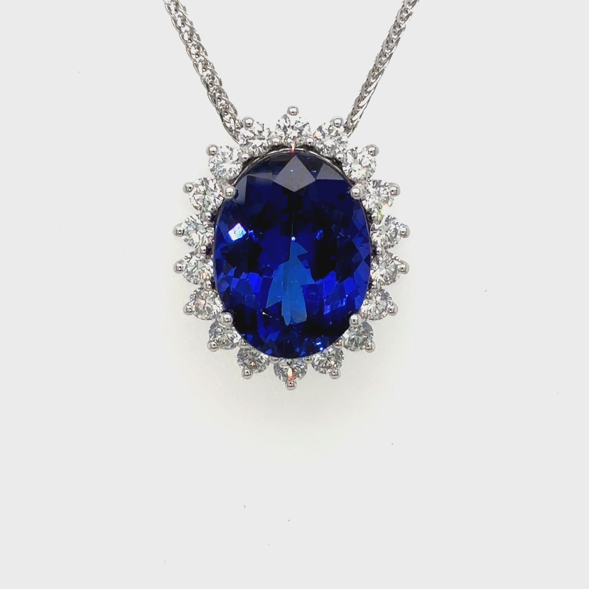 Discover elegance with this stunning pear-shaped tanzanite pendant surrounded by a sparkling floral diamond halo. A timeless luxury piece.