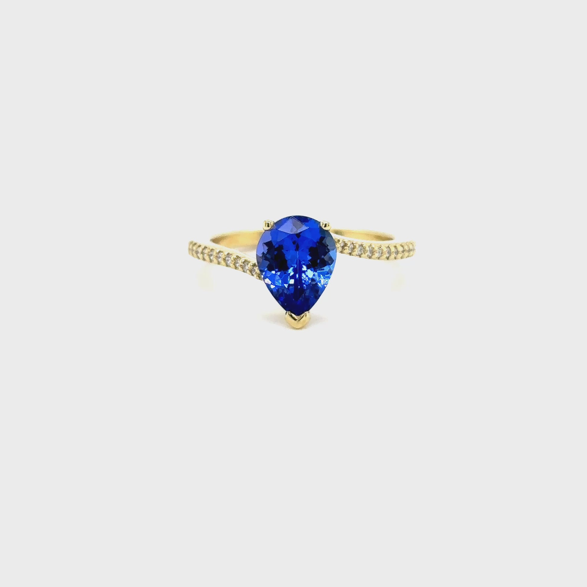 pear shape tanzanite ring, pear cut gemstone ring, tanzanite and diamond ring, elegant pear cut tanzanite jewelry, luxury gemstone ring, women’s tanzanite diamond ring, pear shaped engagement style ring, fine gemstone jewelry, white gold tanzanite and diamond ring, sparkling pear cut tanzanite ring
