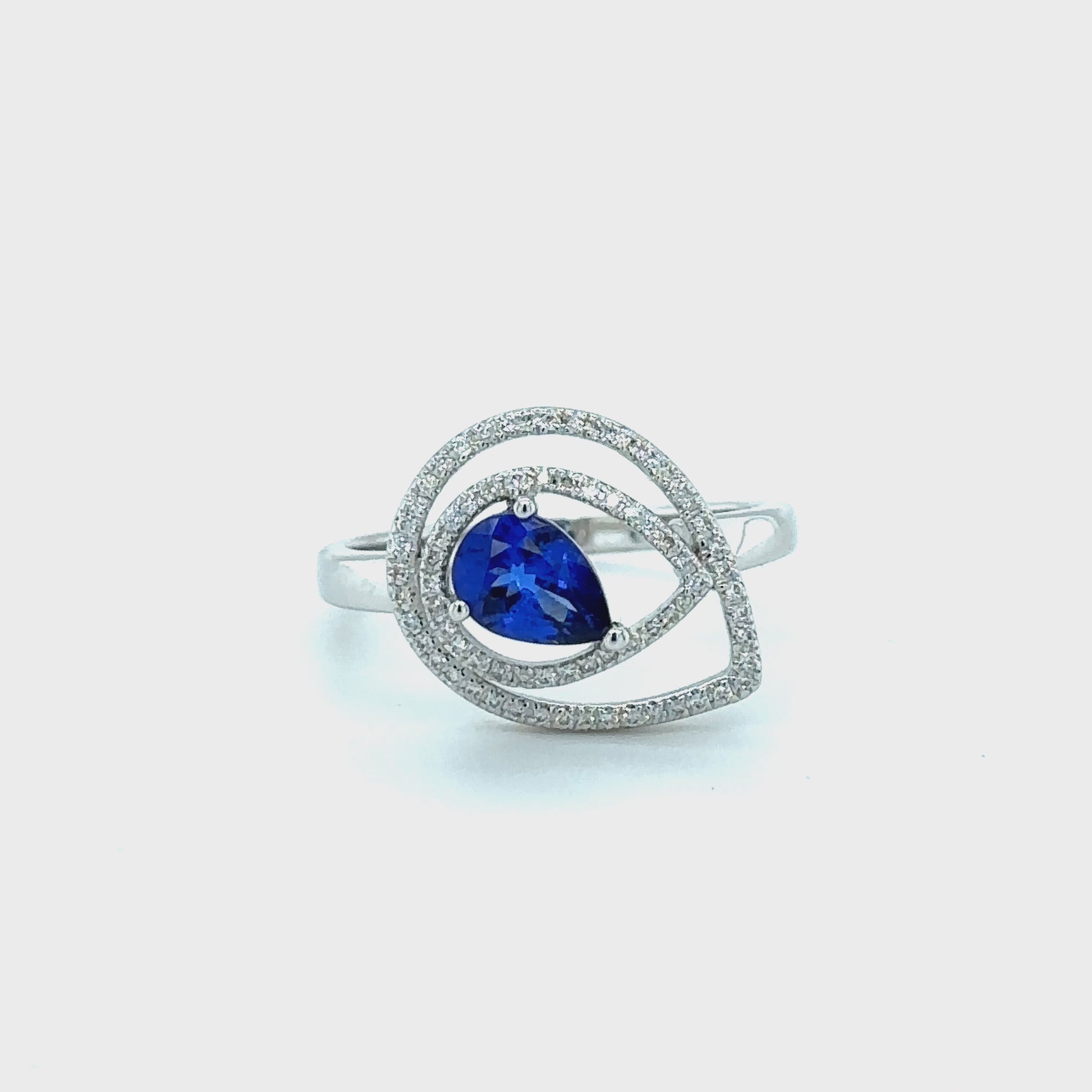 "Pear Shape Tanzanite & Diamond Halo Ring," "Exquisite Pear Shape Tanzanite Ring," "Luxurious Diamond Halo Jewelry," "Elegant Pear Shape Gemstone Ring," "Fine Jewelry with Pear Shape Tanzanite and Diamonds," "High-Quality Diamond Halo Tanzanite Ring," "Statement Pear Shape Gemstone and Diamond Ring," "Sparkling Tanzanite and Diamond Halo Jewelry," "Beautiful Pear Shape Gemstone Ring," "Fashionable Tanzanite & Diamond Halo Ring."