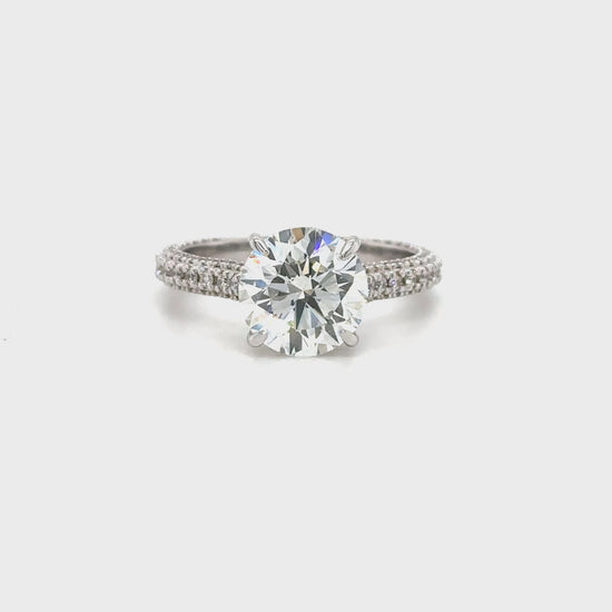 This elegant round solitaire diamond ring features sparkling side stones, perfect for engagements or special occasions.