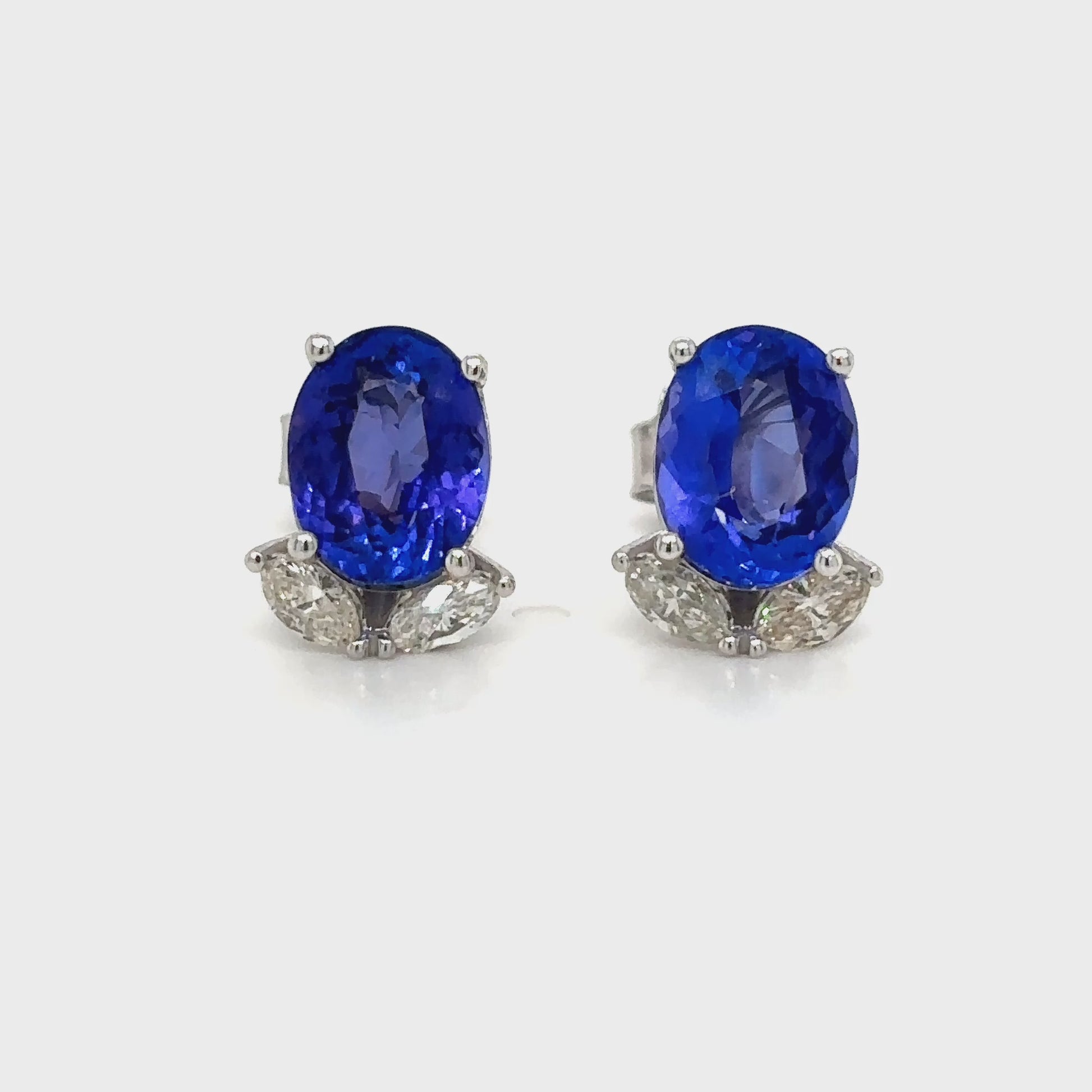 Elegant oval tanzanite and diamond stud earrings that exude sophistication and charm. Each earring features a vibrant oval-shaped tanzanite gemstone, beautifully complemented by sparkling accent diamonds, creating a stunning combination of color and brilliance. Perfect for adding a touch of luxury to any outfit, these earrings offer a timeless design that transitions effortlessly from day to night. Crafted with precision and care, the oval tanzanite and diamond studs are a captivating choice for those who a