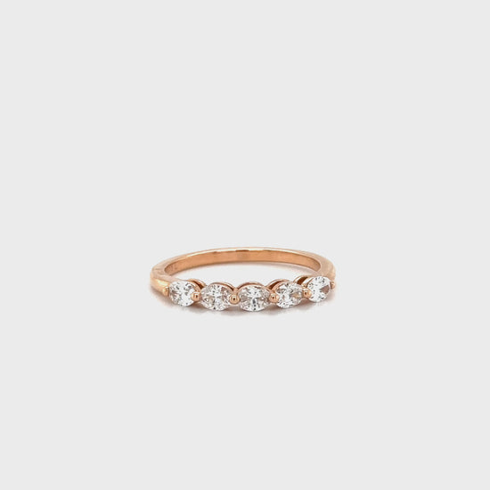 Oval cut diamond ring, half eternity band, sparkling jewelry, elegant design, luxurious accessory, timeless beauty, glamorous style, stunning craftsmanship, dazzling diamonds, exquisite detailing.
