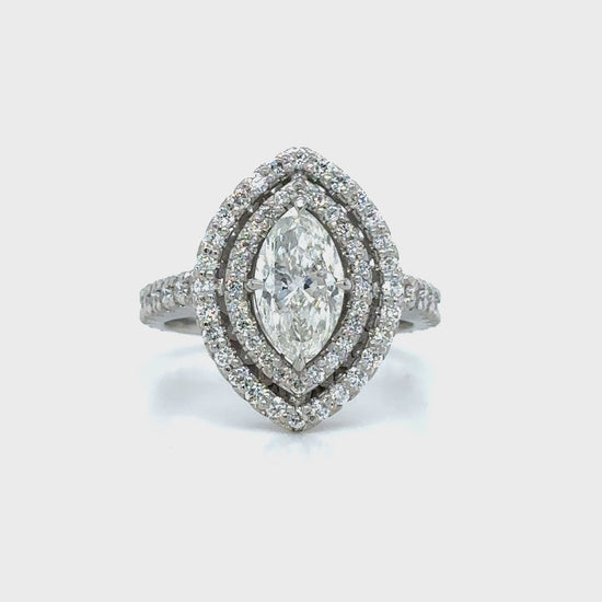 Marquise and round brilliant cut diamond ring with double halo setting, Double halo engagement ring featuring marquise and round brilliant diamonds, Elegant marquise and round diamond ring with sparkling double halo design, Double halo diamond ring showcasing marquise center stone and round accents, Luxury diamond ring with marquise cut center and round brilliant double halo.