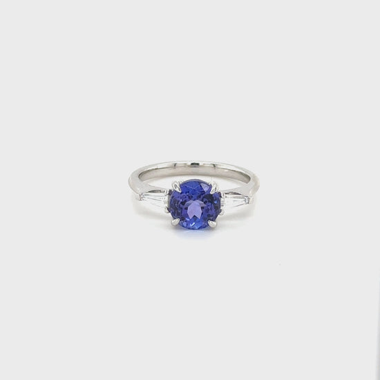 "Round Cut Tanzanite & Diamond Ring," "Exquisite Round Cut Tanzanite Ring," "Luxurious Diamond Jewelry with Round Cut Tanzanite," "Elegant Round Cut Gemstone Ring," "Fine Jewelry featuring Round Cut Tanzanite and Diamonds," "High-Quality Round Cut Tanzanite Ring," "Statement Round Cut Gemstone and Diamond Ring," "Sparkling Tanzanite and Diamond Jewelry with Round Cut," "Beautiful Round Cut Gemstone Ring," "Fashionable Tanzanite & Diamond Ring with Round Cut."