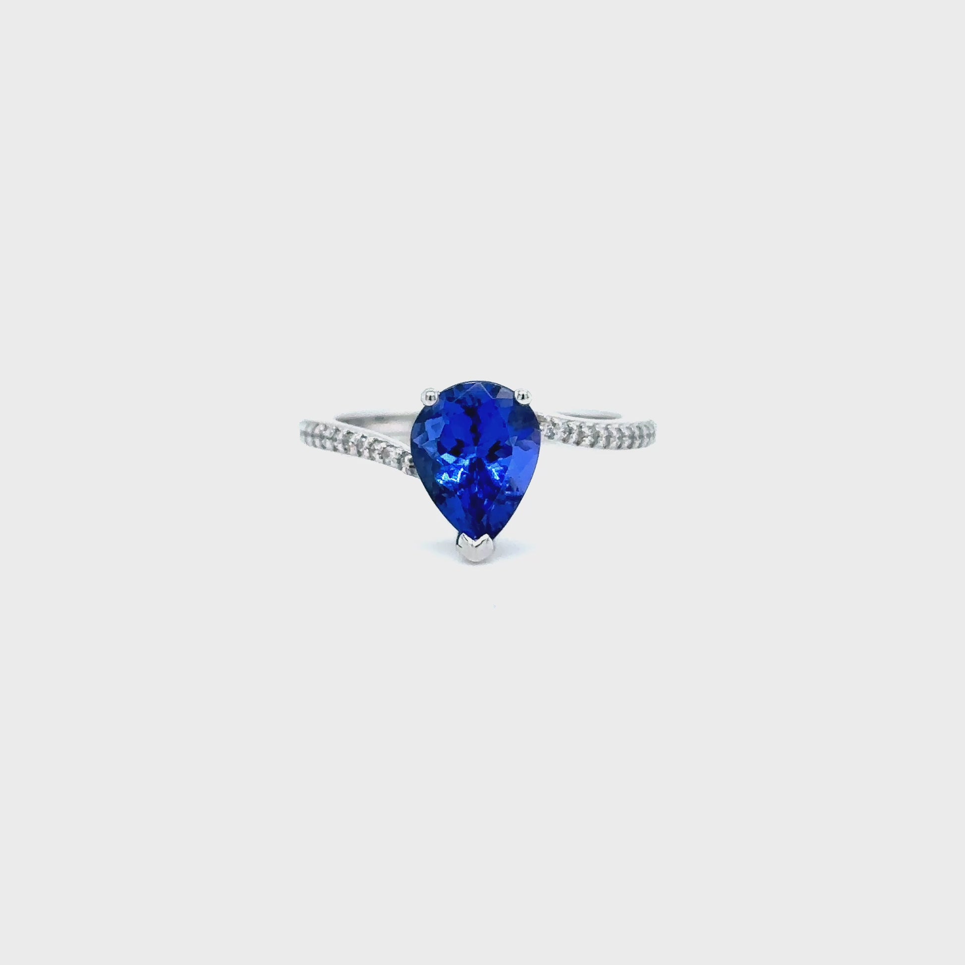 pear shape tanzanite ring, pear cut gemstone ring, tanzanite and diamond ring, elegant pear cut tanzanite jewelry, luxury gemstone ring, women’s tanzanite diamond ring, pear shaped engagement style ring, fine gemstone jewelry, white gold tanzanite and diamond ring, sparkling pear cut tanzanite ring