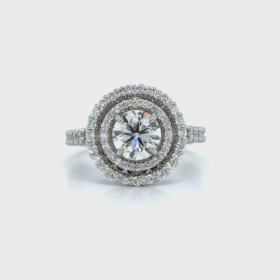 Round brilliant cut diamond ring with double halo setting, Elegant double halo ring featuring round brilliant diamond center, Luxury round diamond engagement ring with double halo design, White gold ring with round brilliant diamond and double halo, Sparkling round cut diamond ring with double halo of accent stones, Round brilliant engagement ring with intricate double halo, Classic round brilliant cut diamond ring in double halo setting