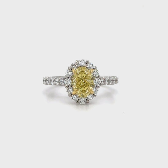 Discover timeless elegance with this Fancy Yellow Oval and Floral Diamond Halo Ring. A stunning blend of luxury and craftsmanship, perfect for any special occasion