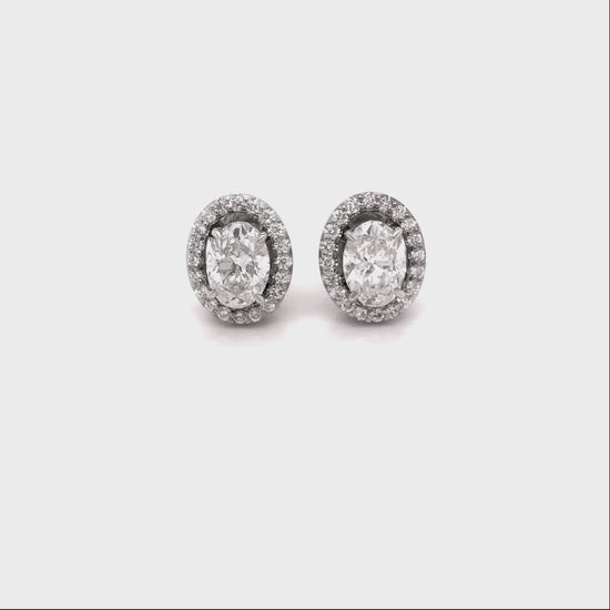 oval diamond halo earrings, diamond stud earrings, oval cut diamond jewelry, halo diamond earrings, elegant diamond studs, women’s fine jewelry, classic diamond earrings, oval halo stud earrings, luxury diamond jewelry, sparkling diamond earrings