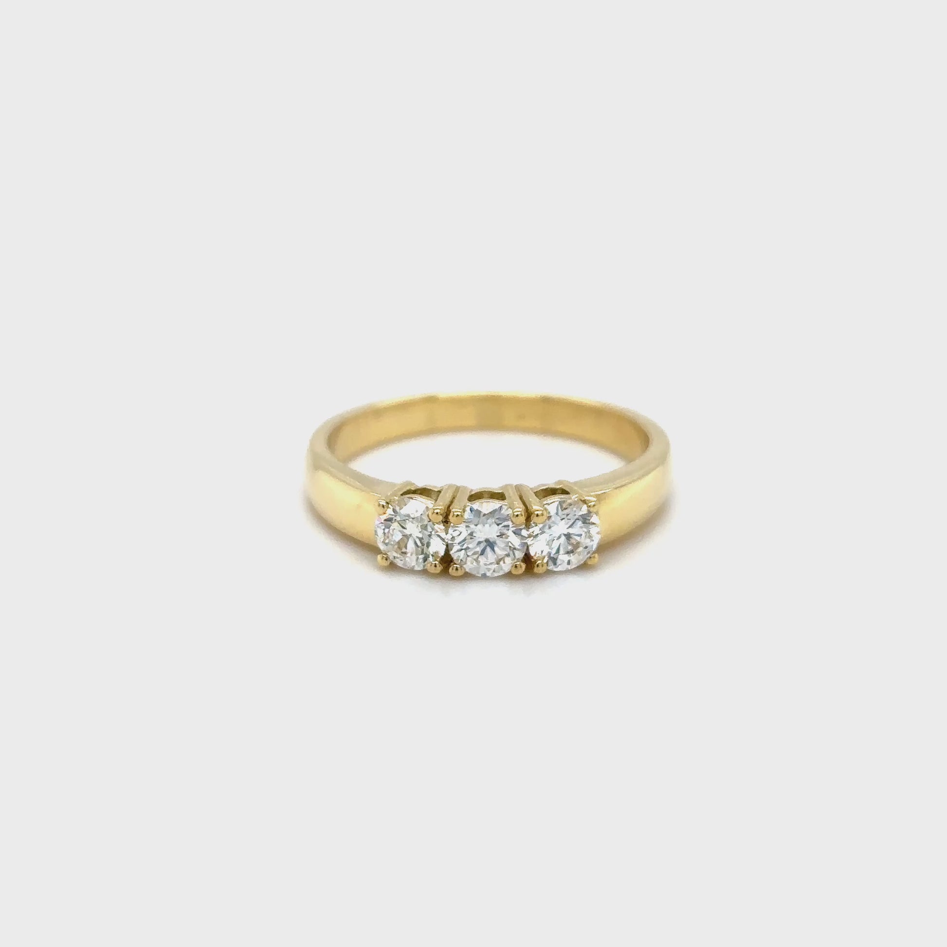round brilliant diamond ring, trilogy diamond ring, yellow gold diamond ring, three stone diamond ring, yellow gold trilogy ring, round cut diamond ring, engagement trilogy ring, yellow gold engagement ring, classic diamond trilogy ring, bridal trilogy ring yellow gold