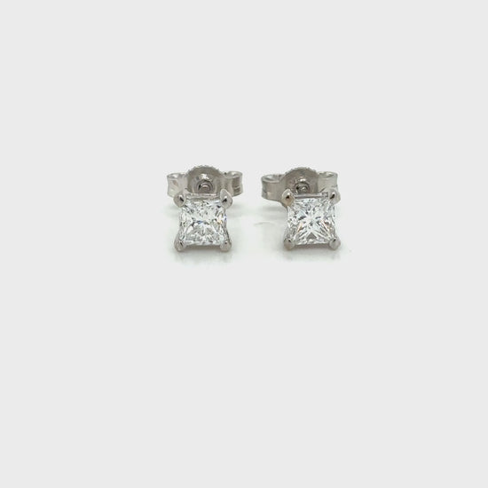 Luxurious stud earrings featuring baguette and round brilliant cut diamonds set in white gold, showcasing a modern and elegant design.