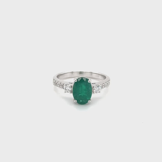 Oval emerald ring, emerald trilogy ring, emerald and diamond ring, diamond trilogy ring, diamond and emerald jewelry, fine jewelry, elegant ring, gemstone ring, luxury jewelry, three-stone ring, green gemstone ring."