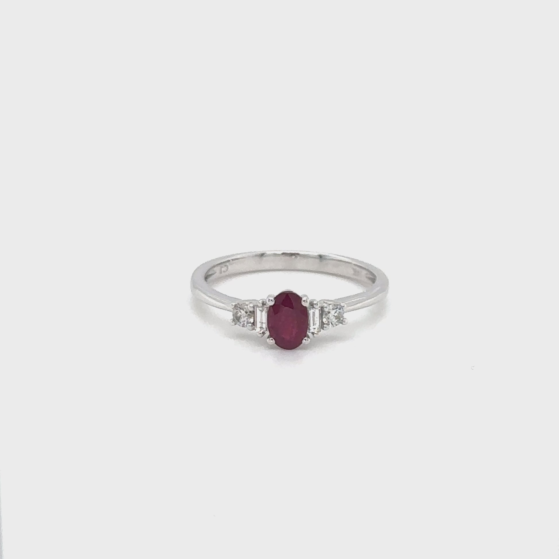 An elegant, oval ruby ring, adorned with sparkling diamonds, perfect for special occasions, adding sophistication and glamour to any ensemble.