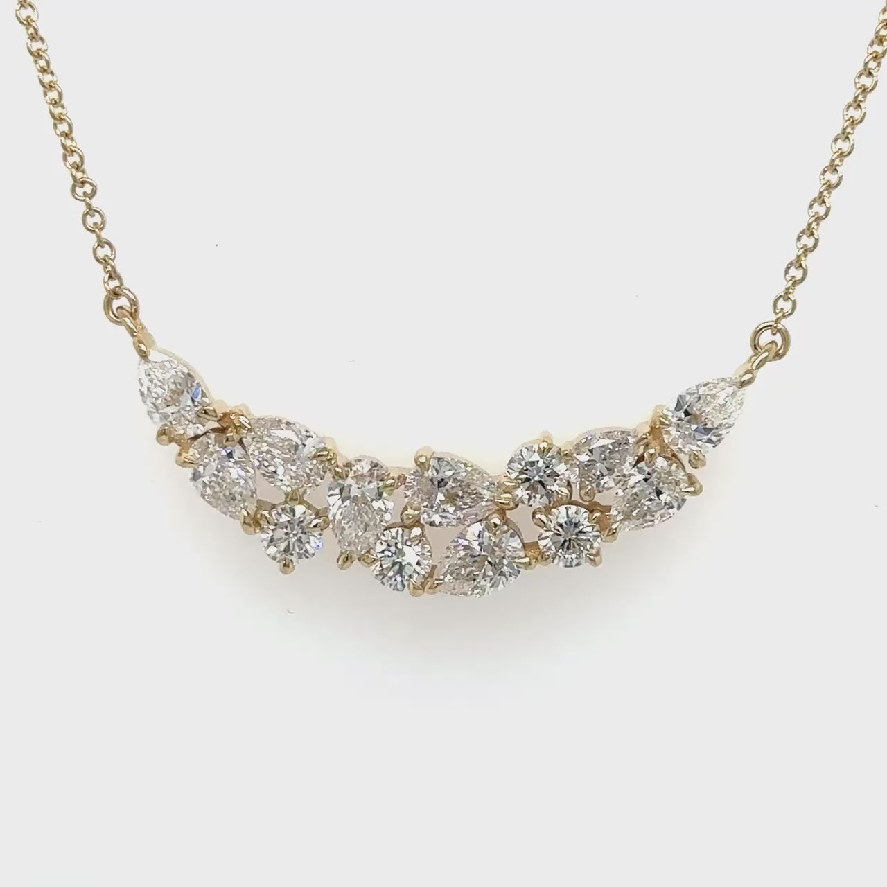A round brilliant diamond pendant, sparkling round brilliant pendant, elegant round pendant, pear-shaped diamond pendant, dazzling pear pendant, pear-shaped drop pendant.