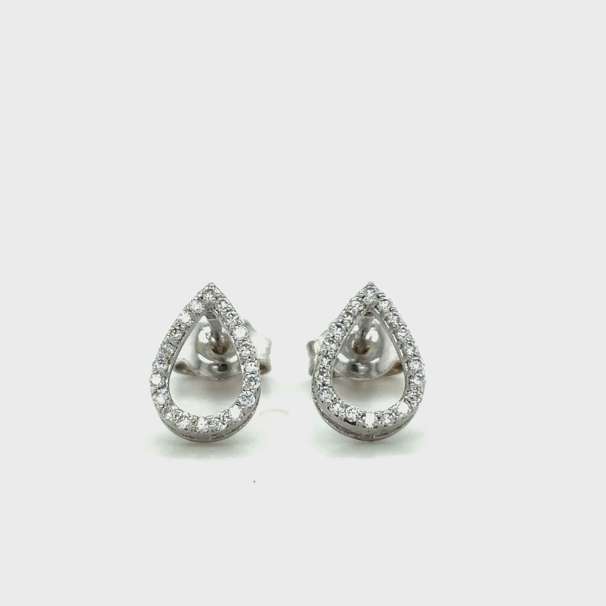 Elegant tear drop halo diamond stud earrings in white gold with sparkling round accent diamonds.