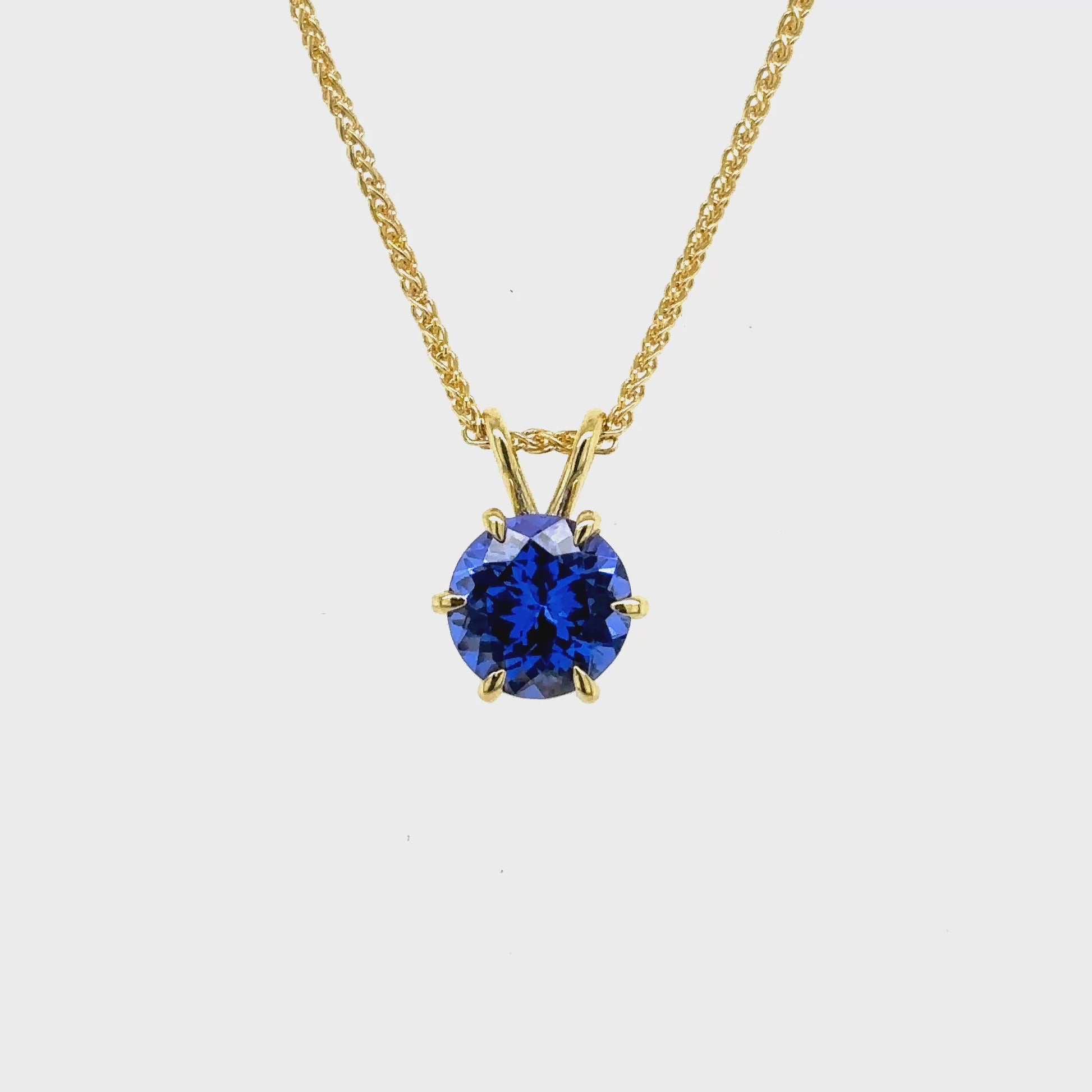 Round Cut Tanzanite Pendant featuring a vibrant violet-blue gemstone set in an elegant metal frame, designed for a timeless and sophisticated look.