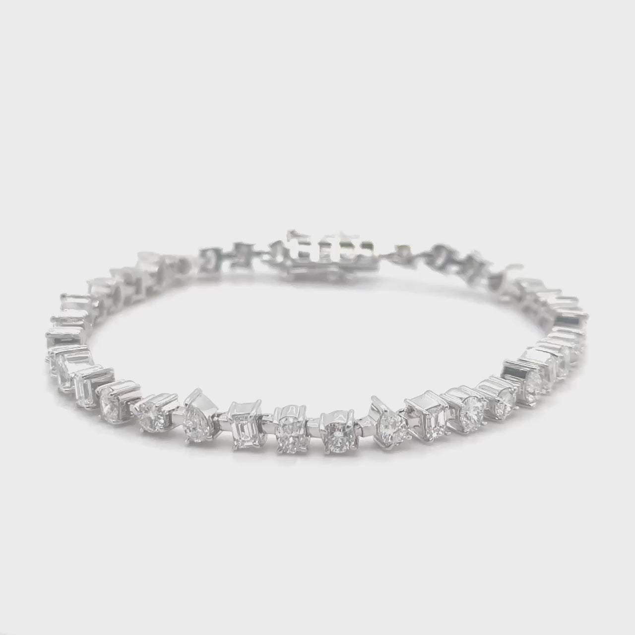 "Multi-Shaped Diamond Tennis Bracelet," "Diamond Tennis Bracelet," "Fine Jewelry," "Luxury Bracelet," "Fashion Bracelet," "Diamond Jewelry," "Sparkling Tennis Bracelet," "Statement Bracelet," "Elegant Jewelry," "Special Occasion Bracelet," "Multi-Cut Diamond Bracelet," "Timeless Jewelry," "Handcrafted Diamond Bracelet," "Versatile Diamond Bracelet," "Designer Tennis Bracelet."