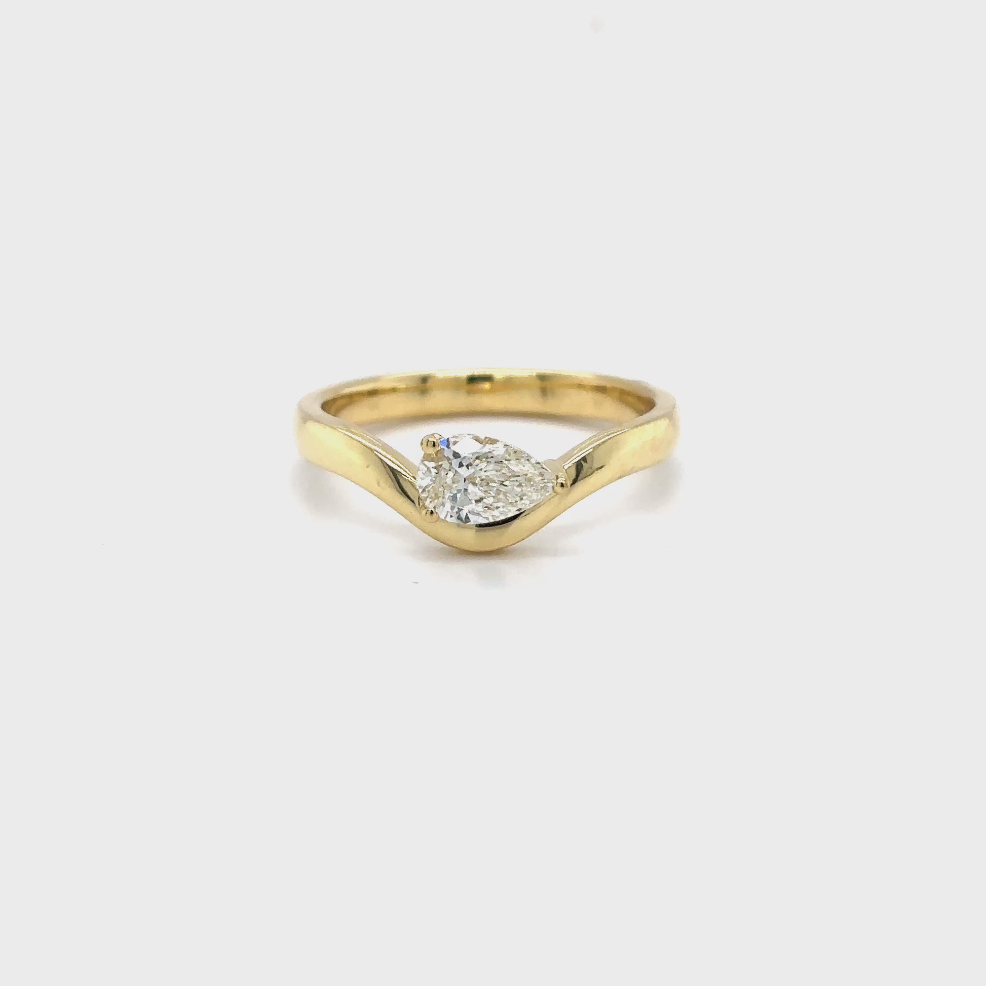 pear shaped diamond ring, yellow gold solitaire ring, bypass engagement ring, east-west diamond solitaire, modern pear diamond ring