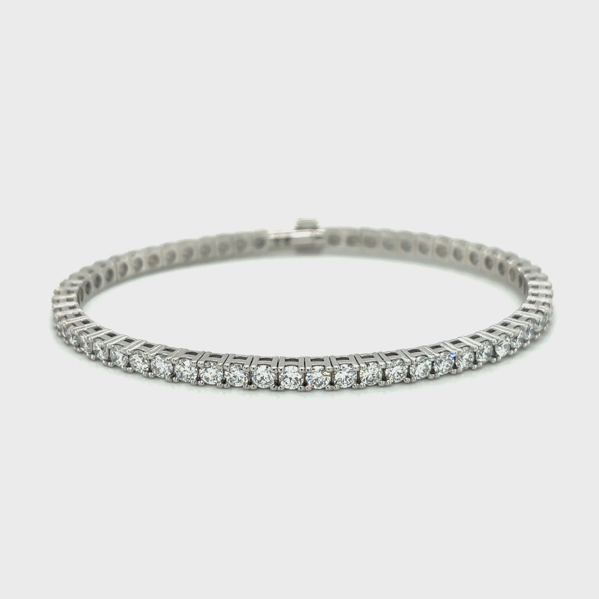 Diamond tennis bracelet with a row of round-cut diamonds set in white gold.