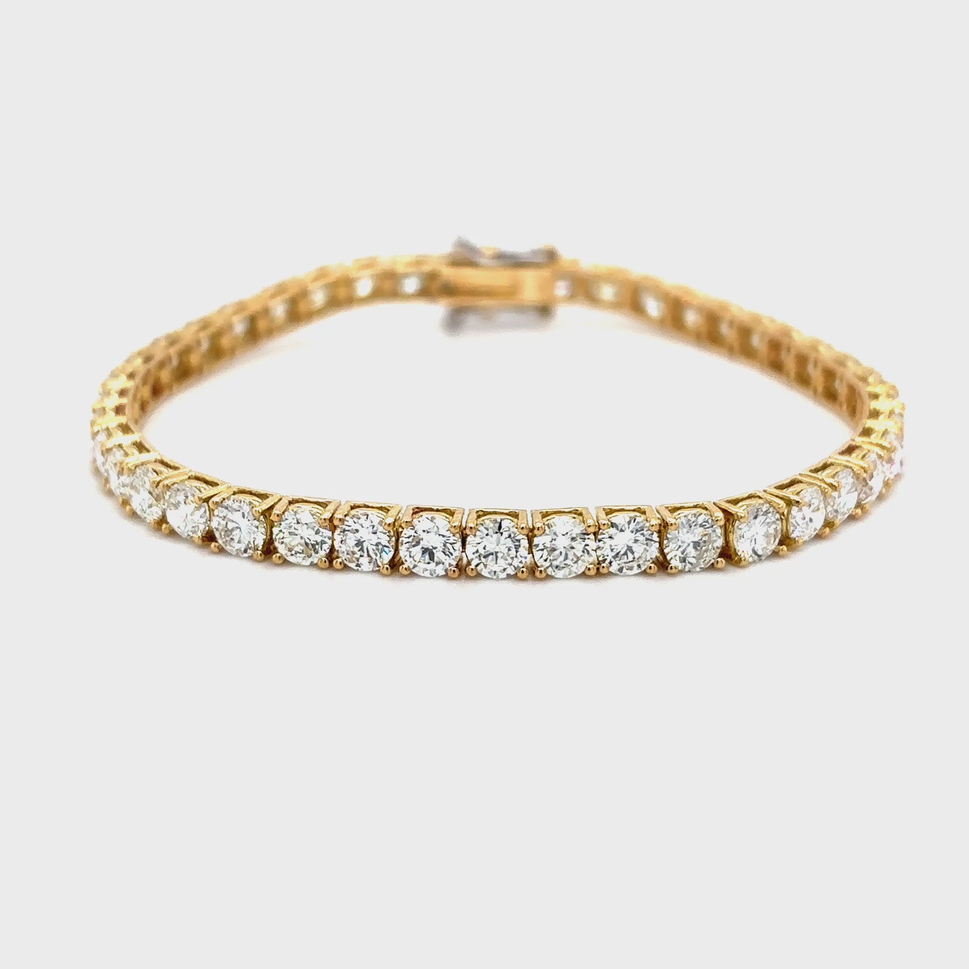 "Classic Diamond Tennis Bracelet with round brilliant diamonds", "Elegant tennis bracelet featuring a continuous row of diamonds", "Close-up of Diamond Tennis Bracelet clasp and setting", "Luxury Diamond Tennis Bracelet in white gold", "Sparkling Diamond Tennis Bracelet for everyday elegance"
