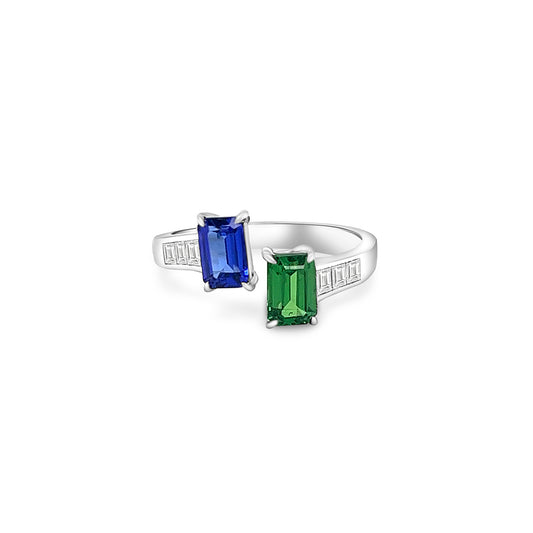 Two stunning gemstones - tsavorite and tanzanite - set in an elegant Toe Et Moi ring. Close-up of the exquisite green tsavorite gemstone in the Toe Et Moi ring. Mesmerizing violet-blue tanzanite gemstone showcased in the luxurious ring design. A side view of the Tsavorite & Tanzanite Ring highlighting the intricate craftsmanship. The Toe Et Moi ring featuring a harmonious blend of tsavorite and tanzanite gemstones.
