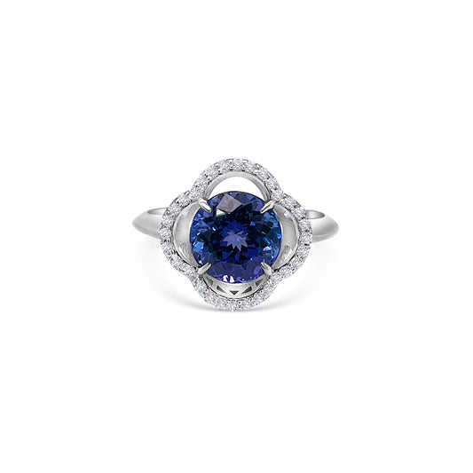 Round tanzanite and diamond halo ring with 2.60ct tanzanite center stone Blue tanzanite gemstone surrounded by sparkling diamonds in a halo setting Exquisite tanzanite and diamond ring, a perfect blend of elegance and opulence Luxurious round tanzanite ring set in white gold with diamond accents Brilliant blue tanzanite encircled by a halo of shimmering diamonds on an engagement ring band Captivating tanzanite and diamond jewelry, a symbol of timeless beauty and sophistication