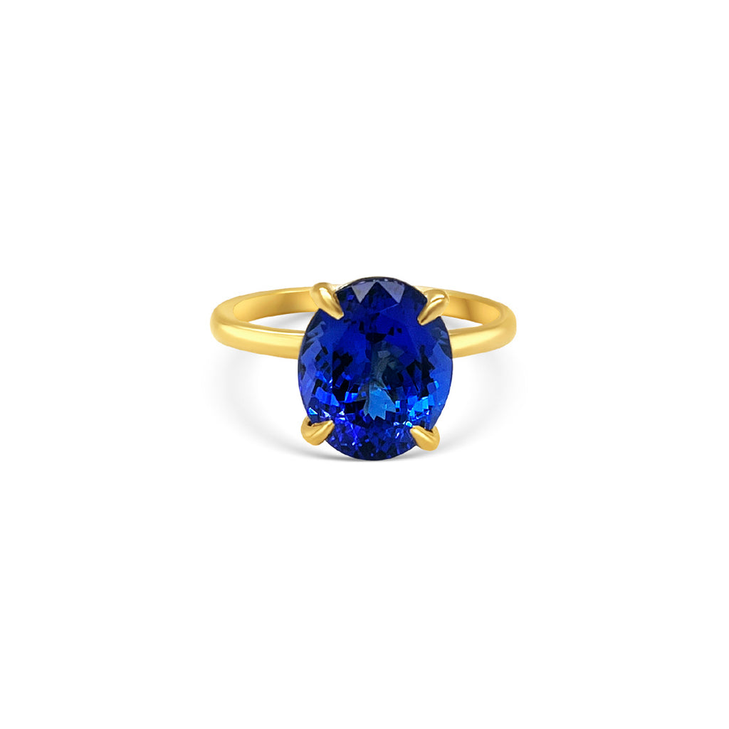 Oval solitaire tanzanite ring 4.10ct tanzanite diamond ring Tanzanite and diamond claw ring Gemstone solitaire jewelry Tanzanite engagement ring Fine jewelry craftsmanship Violet gemstone ring Exquisite diamond accents Luxury gemstone ring Statement solitaire ring Elegance and sophistication Handcrafted claw setting