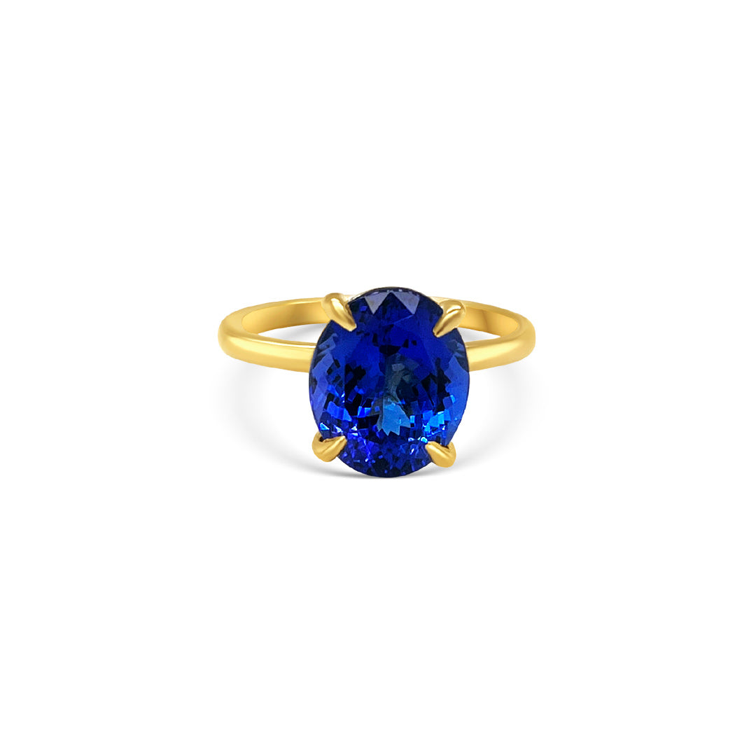 Oval solitaire tanzanite ring 4.10ct tanzanite diamond ring Tanzanite and diamond claw ring Gemstone solitaire jewelry Tanzanite engagement ring Fine jewelry craftsmanship Violet gemstone ring Exquisite diamond accents Luxury gemstone ring Statement solitaire ring Elegance and sophistication Handcrafted claw setting