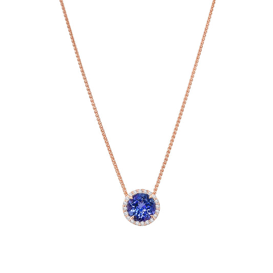 Main Image: "1.90ct Round Tanzanite & Diamond Halo Pendant" Tanzanite Detail: "Vivid Round Tanzanite Gemstone" Diamond Halo: "Diamond Halo Accentuating Tanzanite Pendant" Pendant Profile: "Round Tanzanite & Diamond Halo Pendant Profile" Customizable Liners: "Pendant with Different Open Liner Options" Timeless Elegance: "Halo Pendant with Tanzanite and Diamonds"