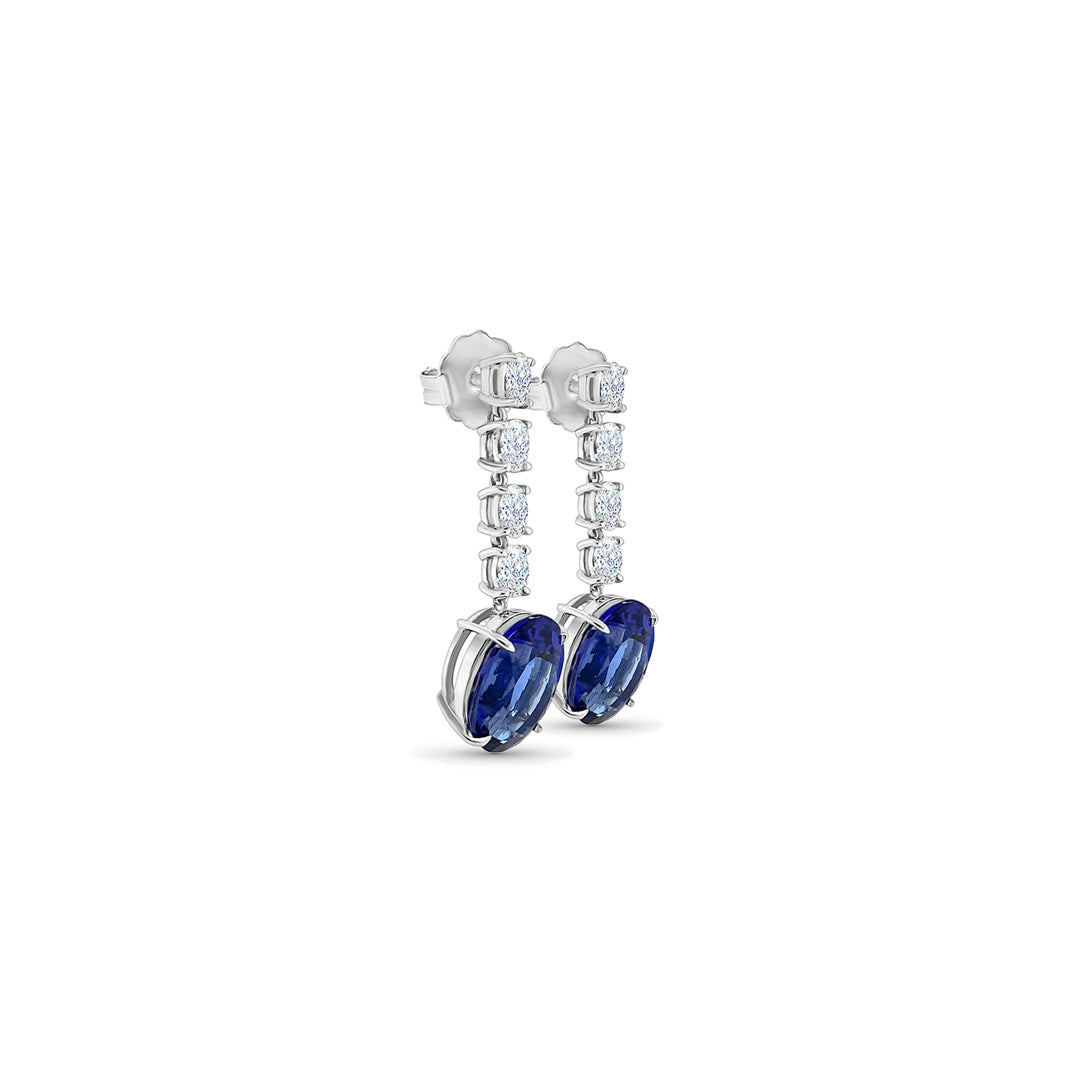 Main Image: "13.00ct Oval Tanzanite & Diamond Dangle Drop Earrings" Tanzanite Detail: "Deep Violet-Blue Oval Tanzanite Gemstone" Diamond Halo: "Halo of Diamonds Surrounding Oval Tanzanite" Earring Profile: "Elegant Profile of Dangle Drop Earrings" Customizable Liners: "Earrings with Different Open Liner Options" Luxurious Presentation: "Oval Tanzanite & Diamond Earrings in Elegant Display"