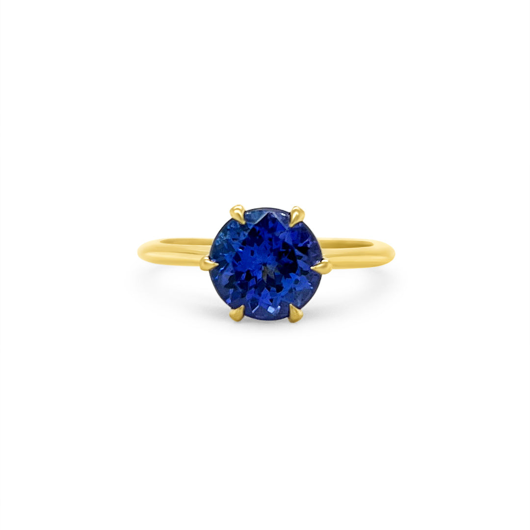 Main Image: "2.30ct Solitaire Round Tanzanite Ring" Tanzanite Detail: "Round-Cut Tanzanite Gemstone" Side View: "Elegant Solitaire Tanzanite Ring" Open Liner Options: "Ring with Different Open Liners" Customizable Tanzanite Ring: "Personalize Your Tanzanite Jewelry" Everyday Elegance: "Everyday Wear Tanzanite Ring"