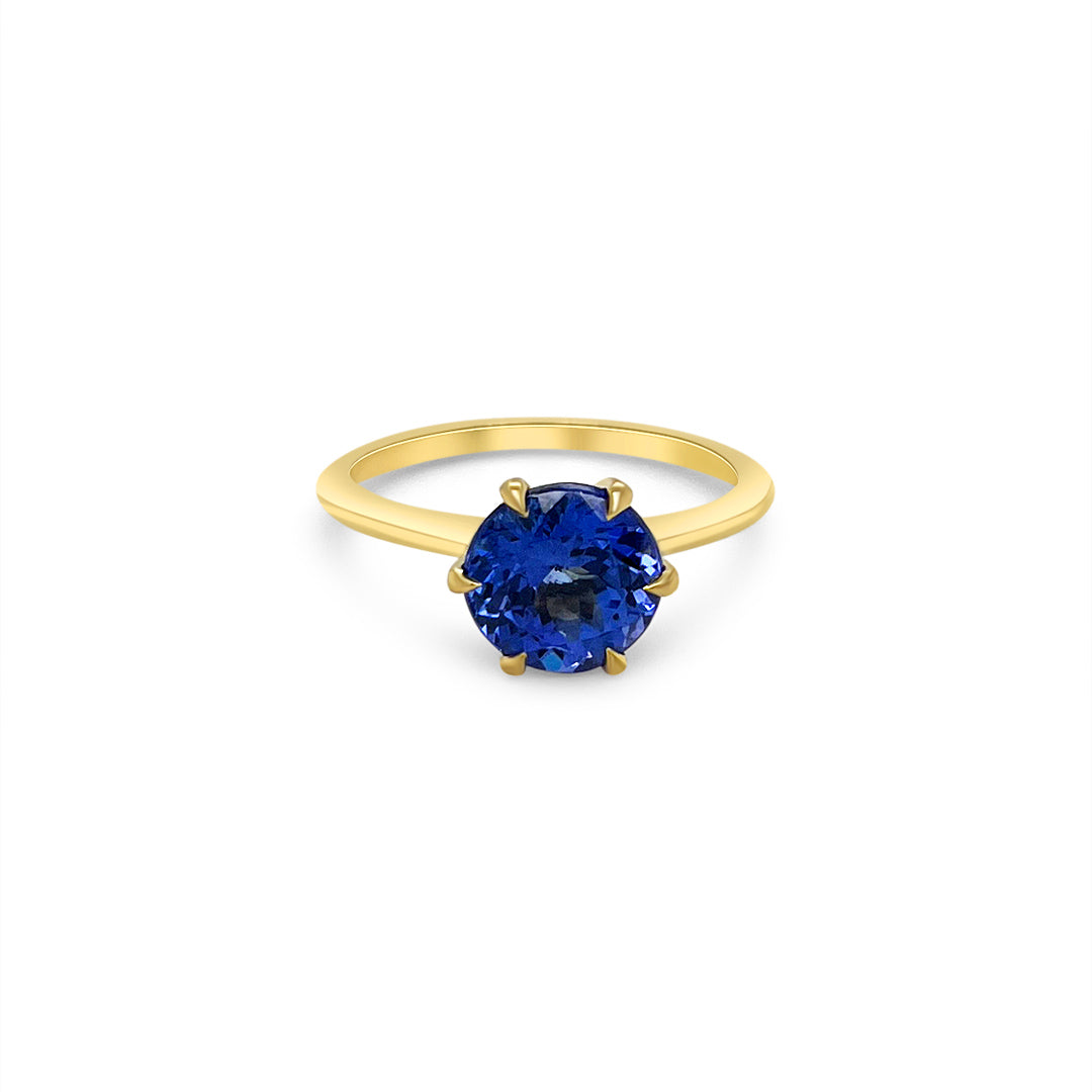 Main Image: "2.30ct Solitaire Round Tanzanite Ring" Tanzanite Detail: "Round-Cut Tanzanite Gemstone" Side View: "Elegant Solitaire Tanzanite Ring" Open Liner Options: "Ring with Different Open Liners" Customizable Tanzanite Ring: "Personalize Your Tanzanite Jewelry" Everyday Elegance: "Everyday Wear Tanzanite Ring"