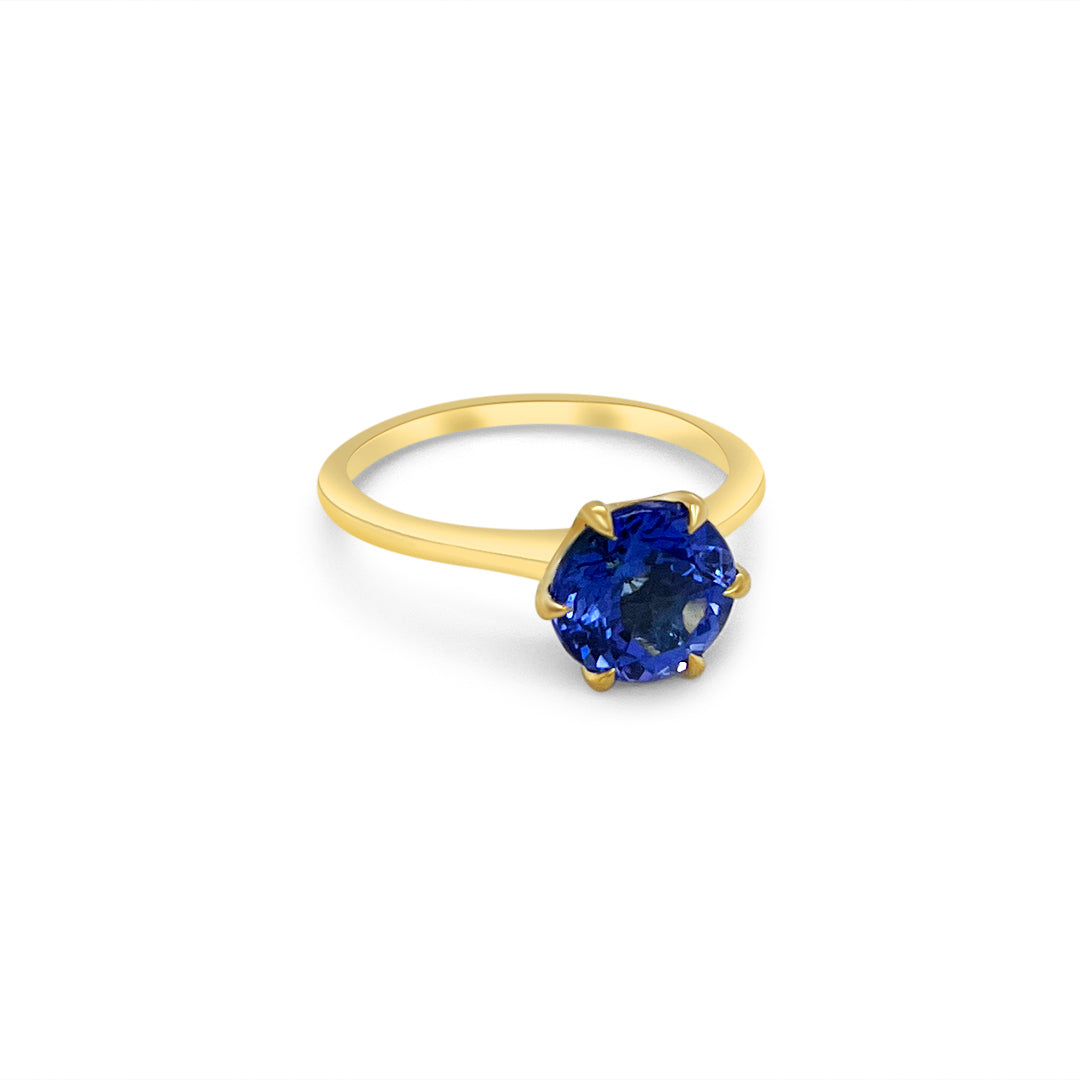 Main Image: "2.30ct Solitaire Round Tanzanite Ring" Tanzanite Detail: "Round-Cut Tanzanite Gemstone" Side View: "Elegant Solitaire Tanzanite Ring" Open Liner Options: "Ring with Different Open Liners" Customizable Tanzanite Ring: "Personalize Your Tanzanite Jewelry" Everyday Elegance: "Everyday Wear Tanzanite Ring"