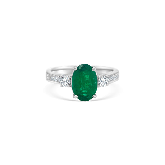 Oval emerald ring, emerald trilogy ring, emerald and diamond ring, diamond trilogy ring, diamond and emerald jewelry, fine jewelry, elegant ring, gemstone ring, luxury jewelry, three-stone ring, green gemstone ring."