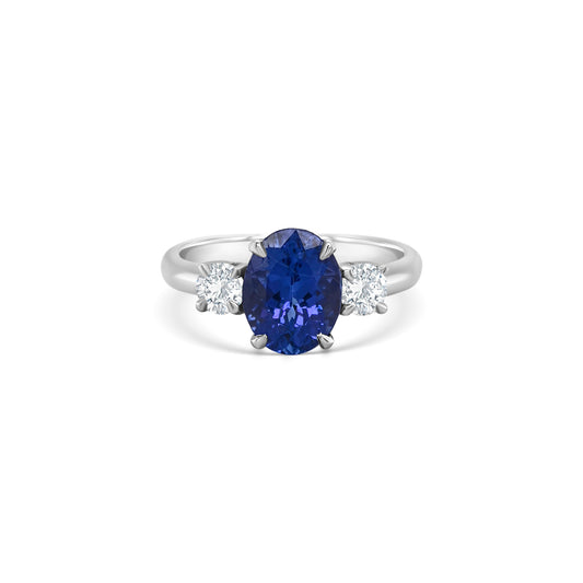tanzanite trilogy ring, oval tanzanite diamond ring, three-stone tanzanite engagement ring, tanzanite and round diamond ring, elegant tanzanite ring